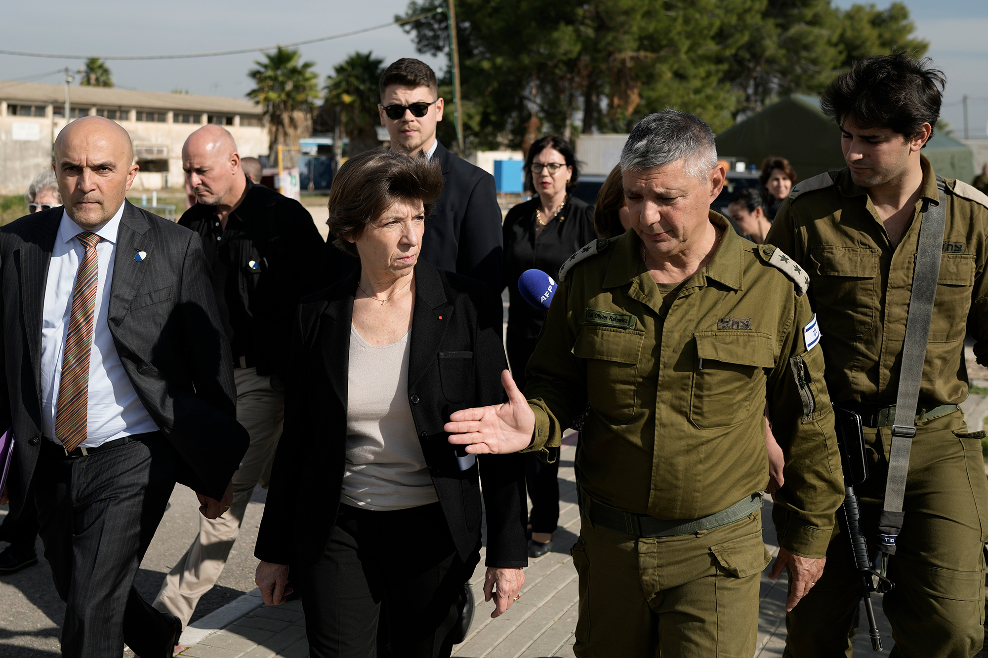 French Foreign Minister Catherine Colonna talks with Israeli Col. Olivier Rafowicz as she arrives at a military base in Israel on December 17.