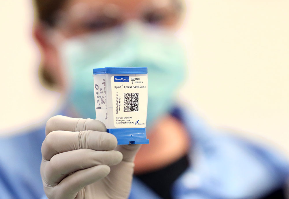 A technician in the testing lab displays a coronavirus test sample at MedStar St. Mary's Hospital April 8 in Leonardtown, Maryland. 