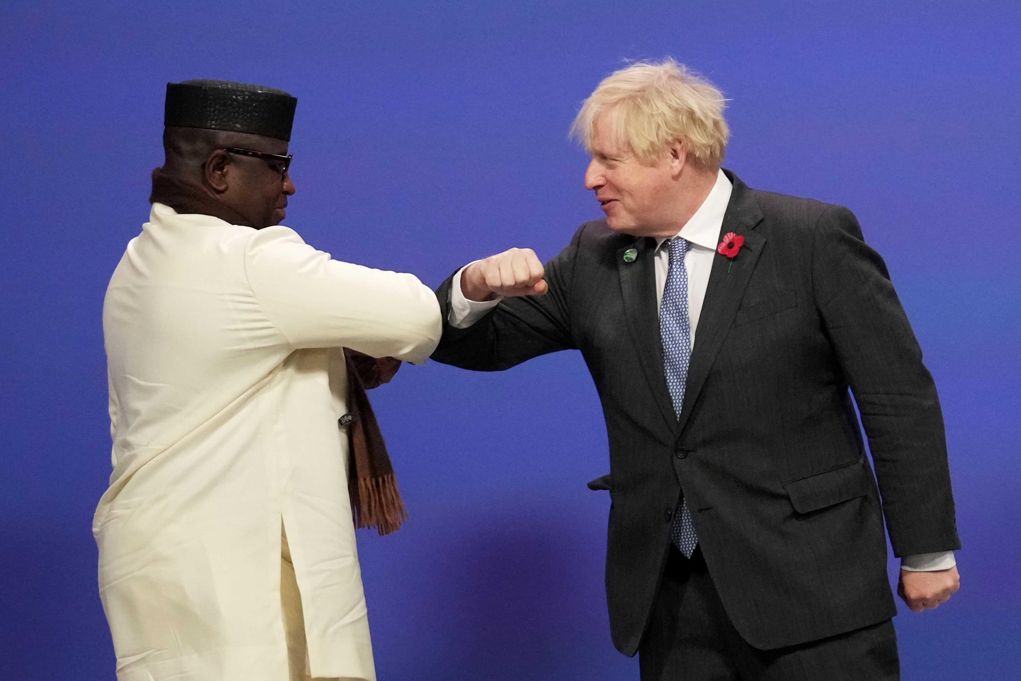 British Prime Minister Boris Johnson greets Sierra Leone's President Julius Maada Bio during arrivals at the Scottish Event Campus in Glasgow, Scotland, on November 1.