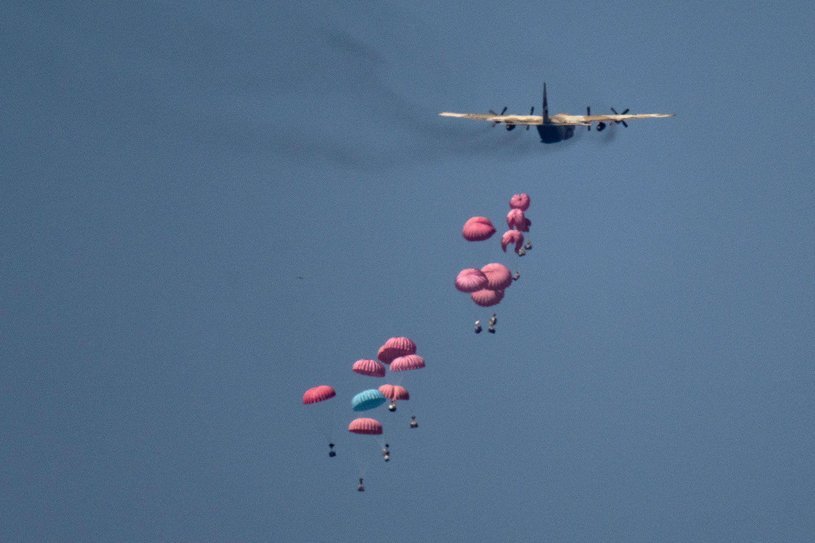 An aircraft airdrops humanitarian aid over northern Gaza Strip, as seen from southern Israel, Wednesday, March 20. 