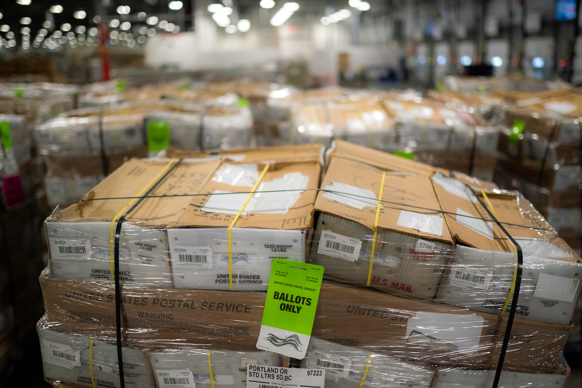 Pallets filled with mail-in ballots fill an unloading area at a U.S. Postal Service processing and distribution center on October 14 in Portland.