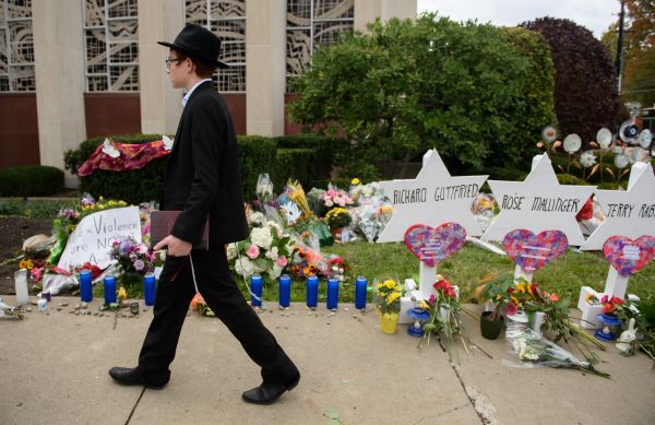 An orthodox jewish schoolboy passes a memorial for victims of the mass shooting that killed 11 people at the Tree Of Life Synagogue on Oct. 29, 2018 in Pittsburgh, Pennsylvania. 