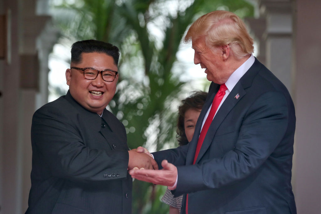 In this handout photo, North Korean leader Kim Jong-un shakes hands with President Donald Trump during their historic U.S.-DPRK summit at the Capella Hotel on Sentosa island on June 12, 2018 in Singapore.