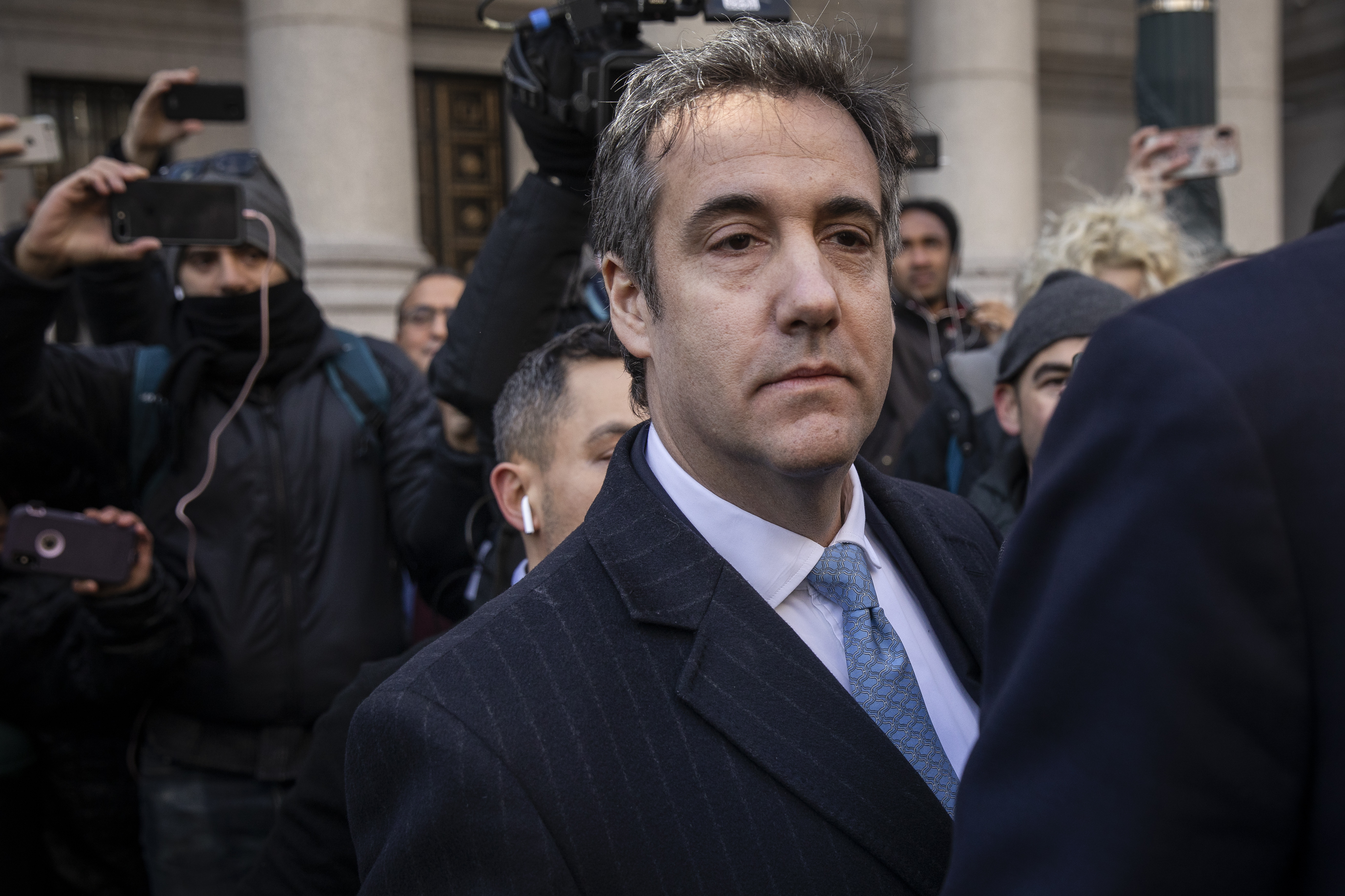 Michael Cohen, who pleaded guilty to making false statements to Congress in the Mueller investigation, exits federal court.