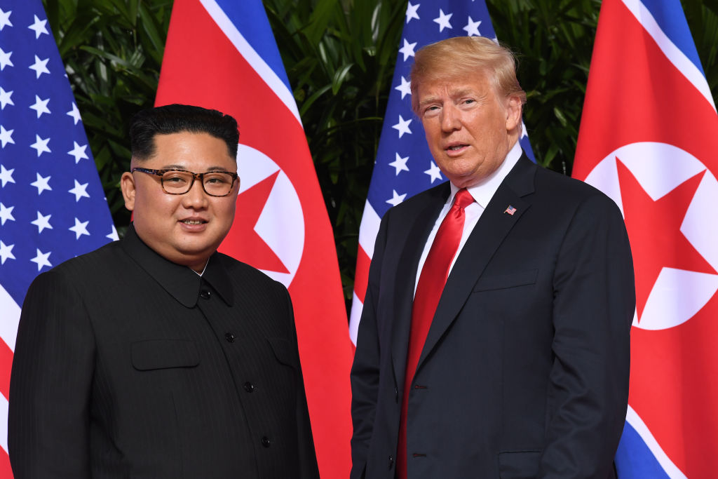 President Donald Trump (R) meets with North Korean leader Kim Jong Un (L) at the start of their historic summit at the Capella Hotel on Sentosa island in Singapore on June 12, 2018.