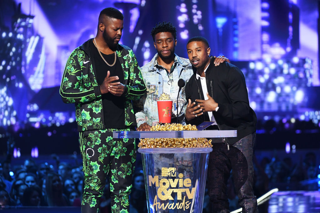 Actors Winston Duke, Chadwick Boseman, and Michael B. Jordan accept the Best Movie award (Presented by Toyota) for 'Black Panther' onstage during the 2018 MTV Movie And TV Awards. 