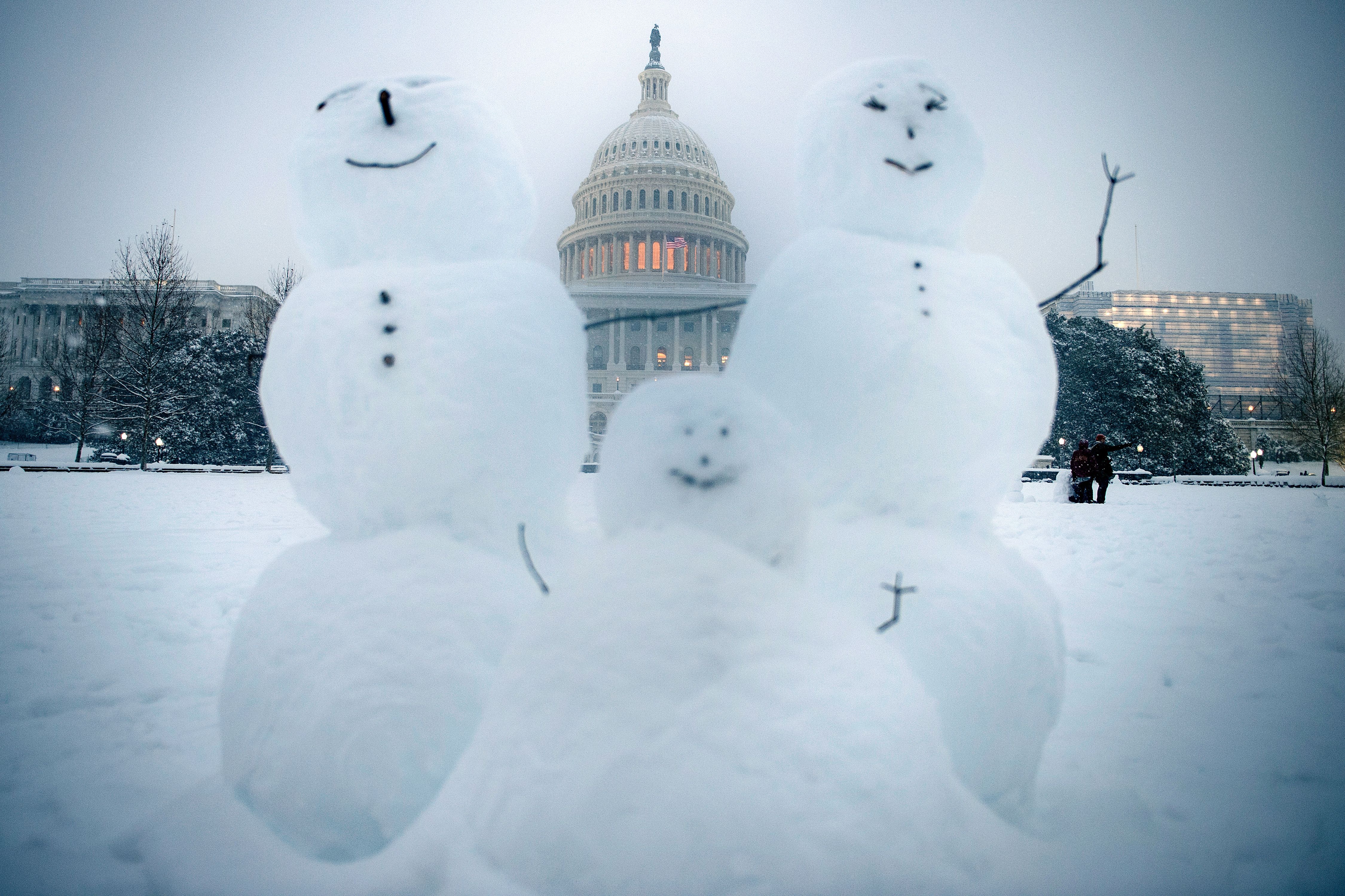 Snowmen are seen on Capitol Hill during a winter storm Sunday in Washington, DC.
