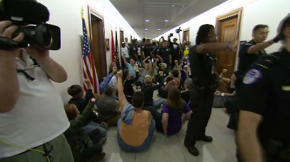 Protesters and police in the Dirksen Senate Office Building