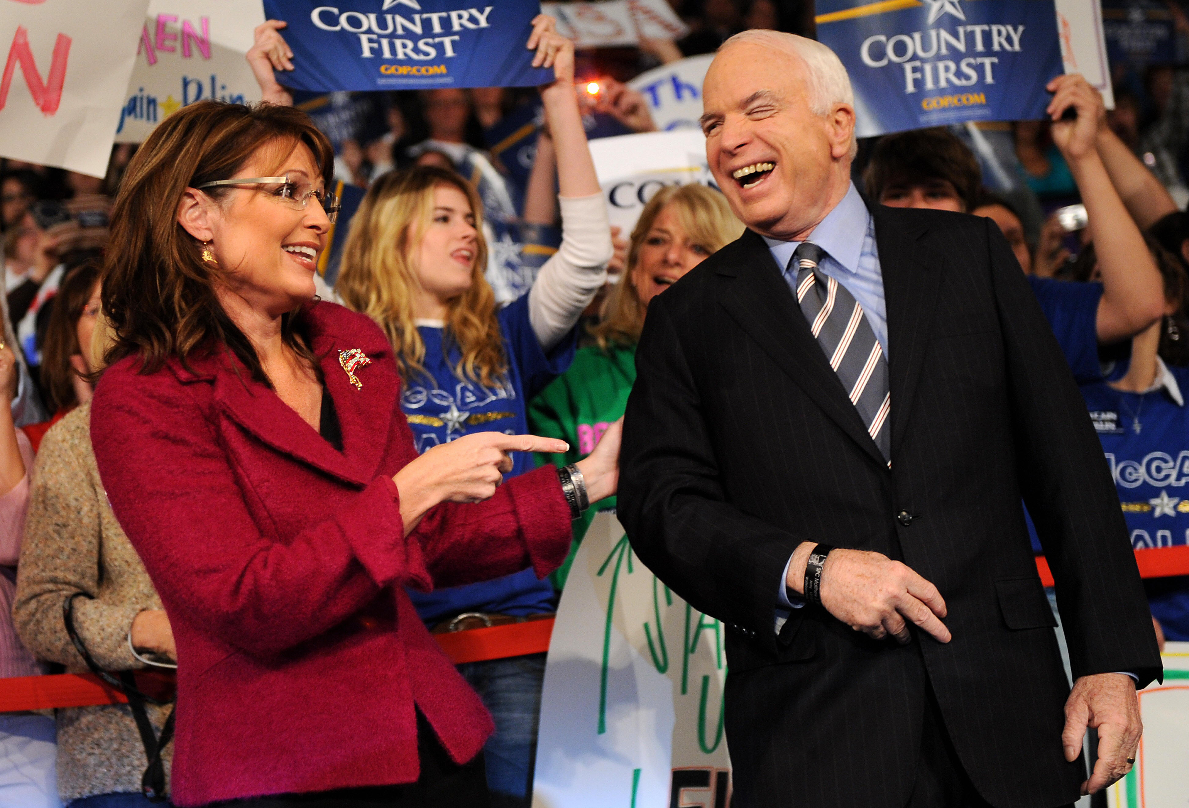 John McCain and his vice presidential candidate Alaska Gov. Sarah Palin laugh during a campaign rally in Pennsylvania in 2008