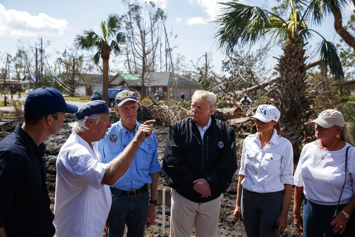 A Lynn Haven, Florida, homeowner, second left, talks with from left, FEMA director Brock Long, Florida Gov. Rick Scott, third from left, President Donald Trump, first lady Melania Trump and Mayor Margo Anderson as they tour a neighborhood affected by Hurricane Michael on Monday. 