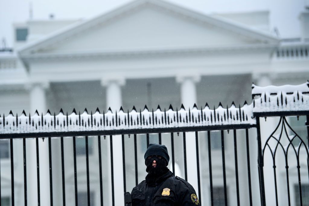 A member of the Secret Service stands guard outside the White House during the 23rd day of the US government shutdown Jan. 13, 2019 in Washington, DC. 