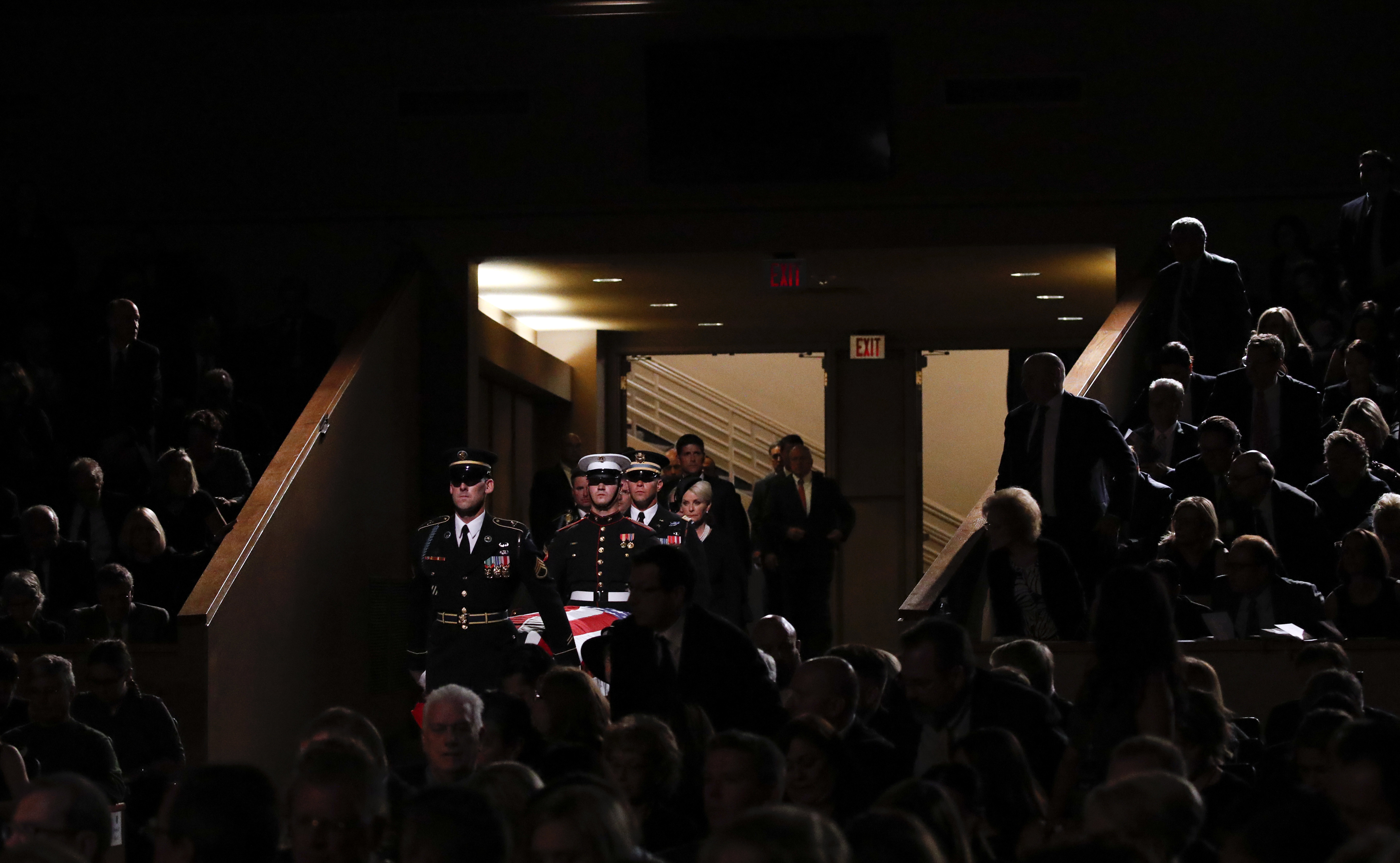 A military honor guard carries the casket into the North Phoenix Baptist Church for a memorial service for Sen. John McCain on Aug. 30, 2018, in Phoenix. 