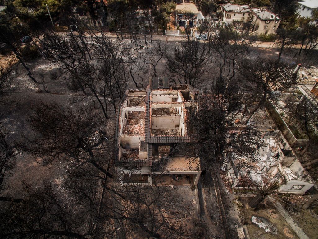 An aerial view shows burnt houses following a wildfire in the village of Mati, near Athens, on July 24, 2018.
