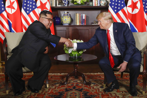 US President Trump shakes hands with North Korea leader Kim Jong Un during their first meetings at the Capella resort on Sentosa Island Tuesday, June 12, 2018 in Singapore.