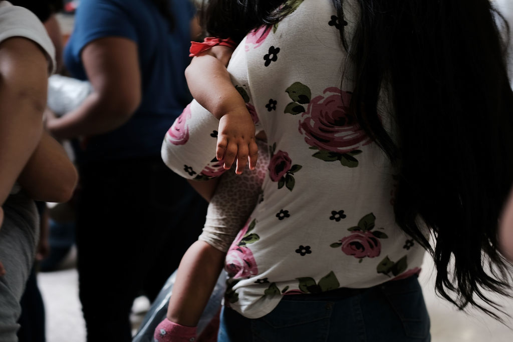 Dozens of women and their children, many fleeing poverty and violence in Honduras, Guatamala and El Salvador, arrive at a bus station following release from Customs and Border Protection on June 22, 2018 in McAllen, Texas. 