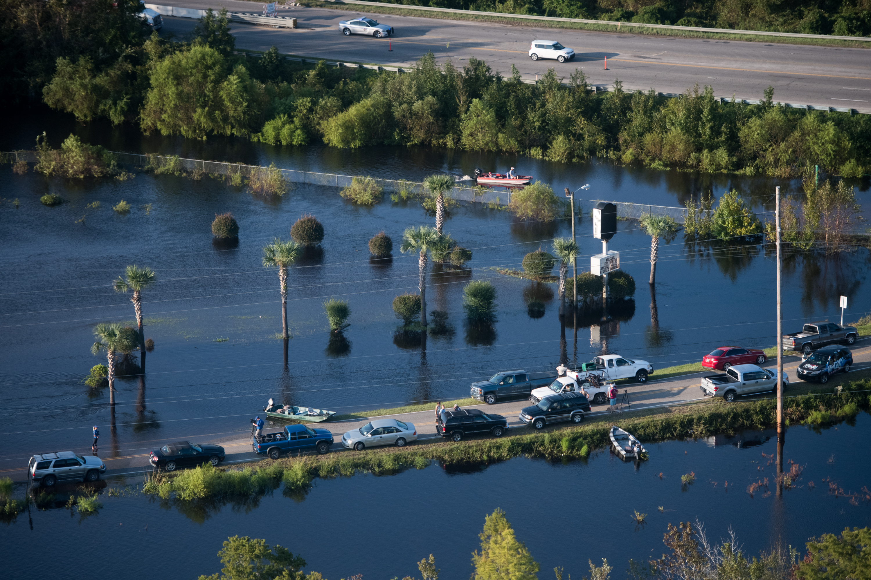 People use a road as a boat ramp on Monday in Conway, South Carolina.
