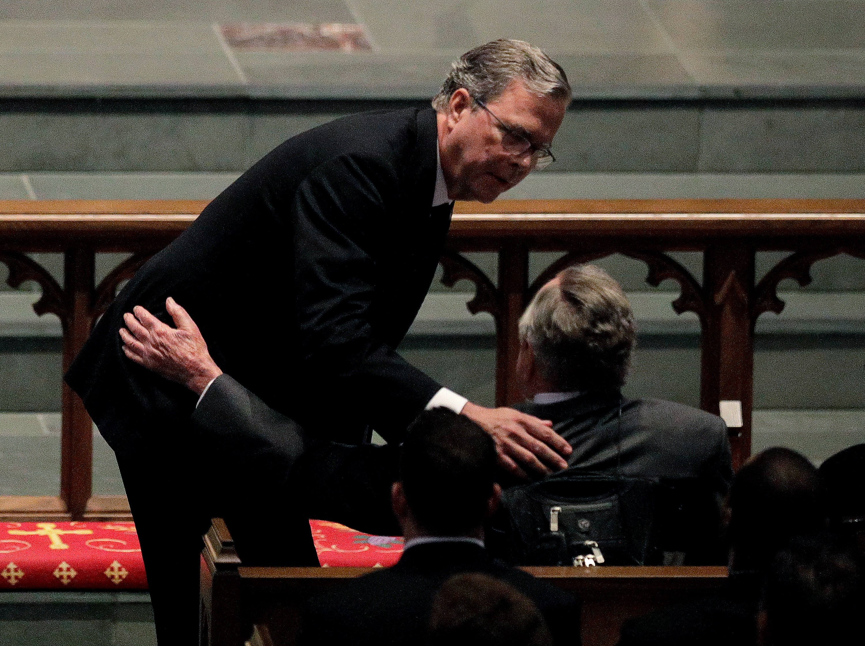 Jeb Bush comforts his father, former President George H.W. Bush, during a funeral service for his mother, former first lady Barbara Bush in April. 