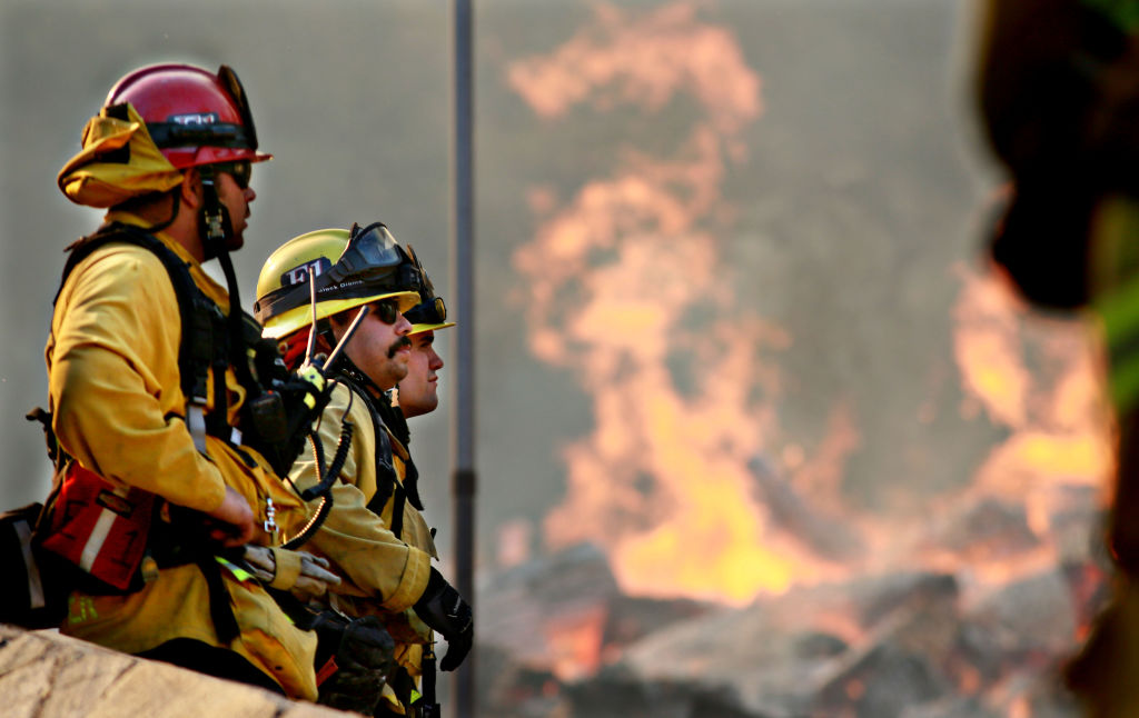 Firefighters battle a blaze at the Salvation Army Camp on Nov. 10, 2018 in Malibu, California.
