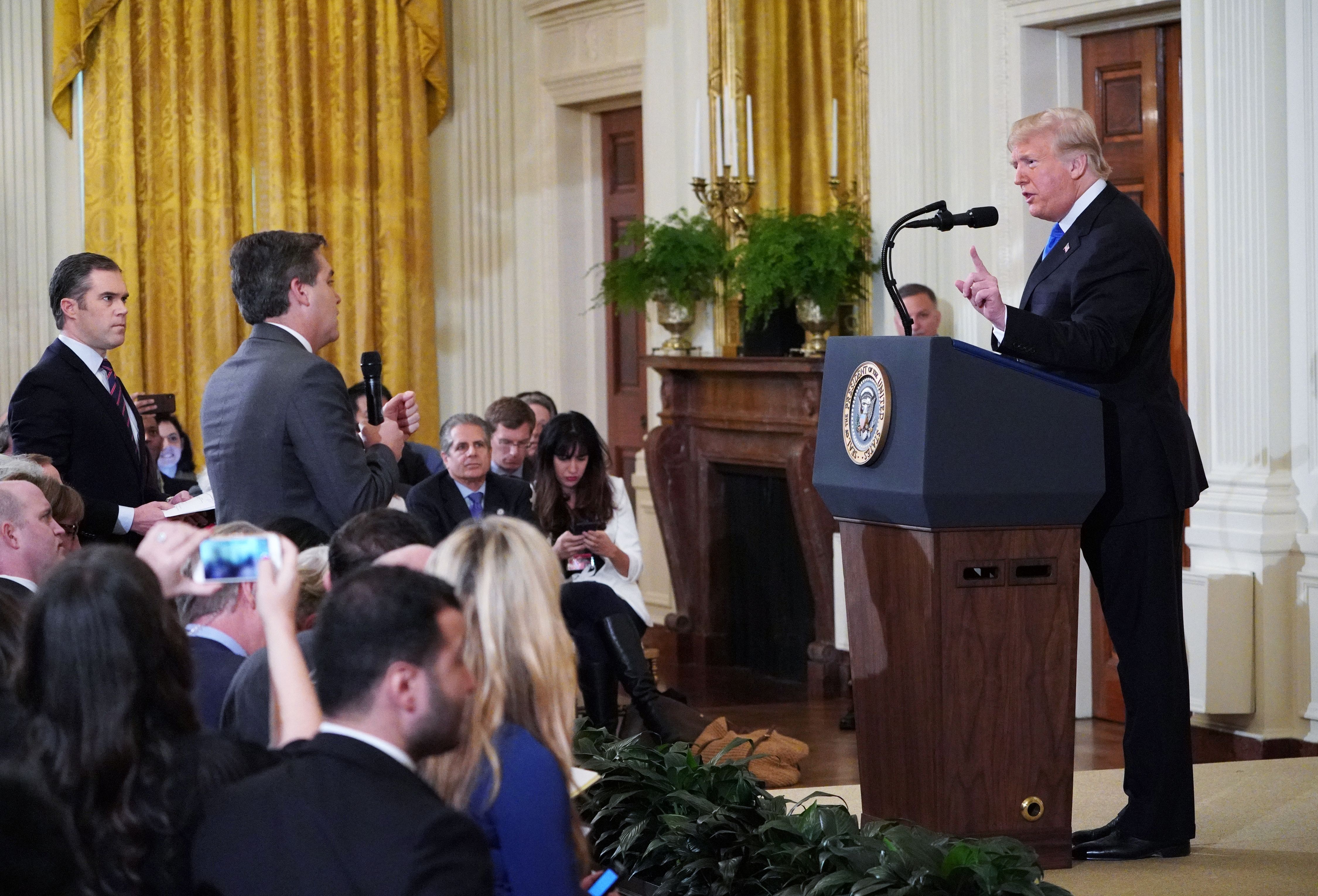 Trump gets into a heated exchange with CNN chief White House correspondent Jim Acosta (center) as NBC correspondent Peter Alexander (left) looks on.
