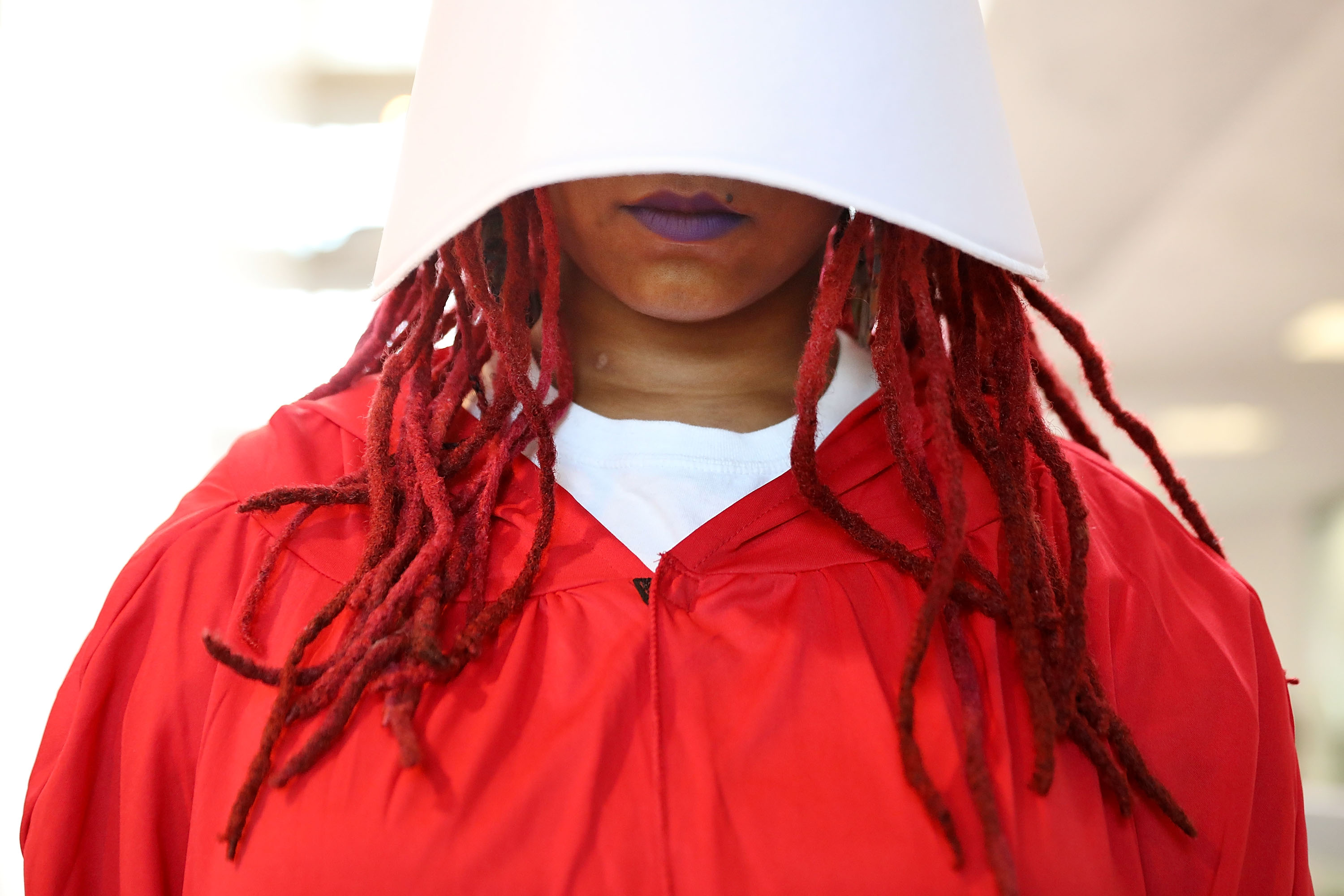 A demonstrator dressed as a character from "The Handmaid's Tale" protests outside the hearing room where Supreme Court nominee Judge Brett Kavanaugh is testifying before the Senate Judiciary Committee in the Hart Senate Office Building on Capitol Hill on Sept. 5, 2018 in Washington, DC. 
