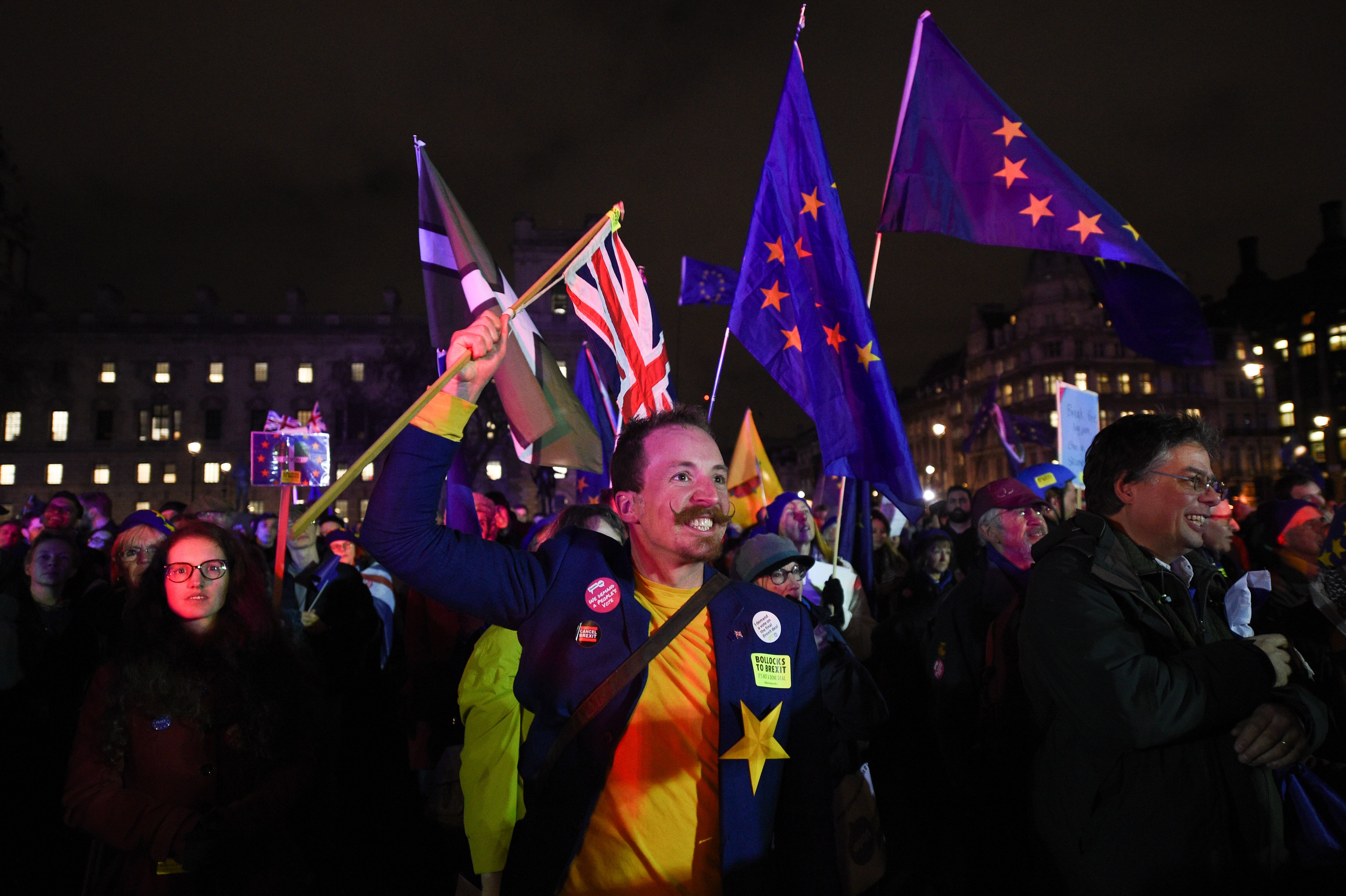 Anti-Brexit supporters celebrate in Parliament Square, central London, following the outcome of the vote. 