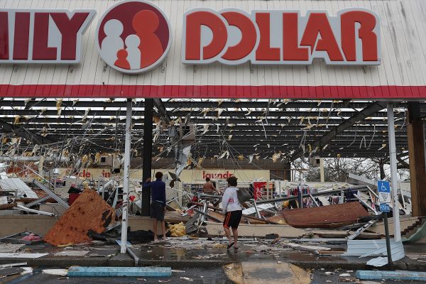 People look on at a damaged Family Dollar store after Hurricane Michael passed through Panama City, Florida, on Wednesday.