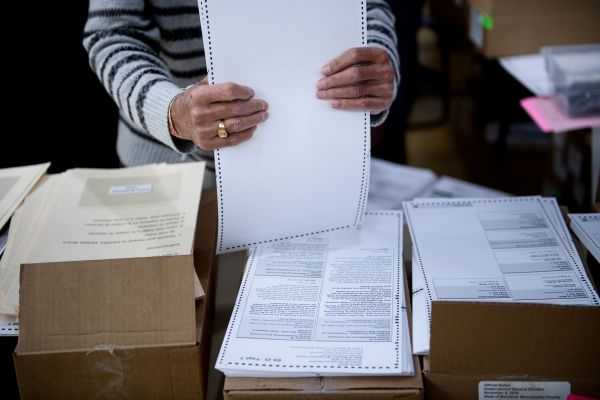 A man prepares ballots on Oct. 25 during early voting in Potomac, Maryland.