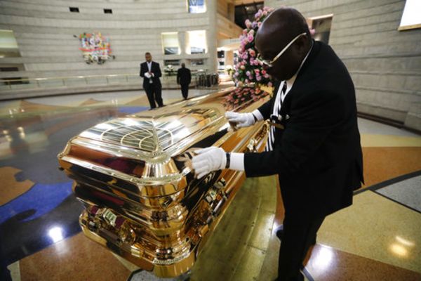 Vincent Street wipes down the casket of legendary singer Aretha Franklin at the Charles H. Wright Museum of African American History in Detroit on Aug. 29, 2018.