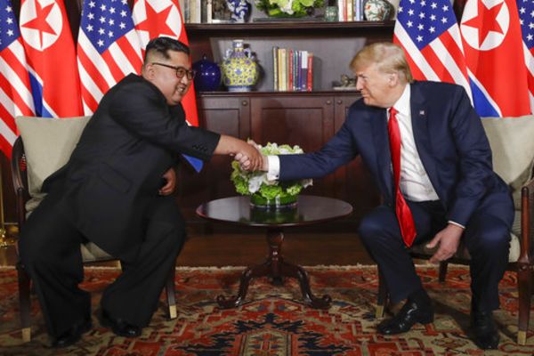 US President Trump shakes hands with North Korea leader Kim Jong Un during their first meetings at the Capella resort on Sentosa Island Tuesday, June 12, 2018 in Singapore.