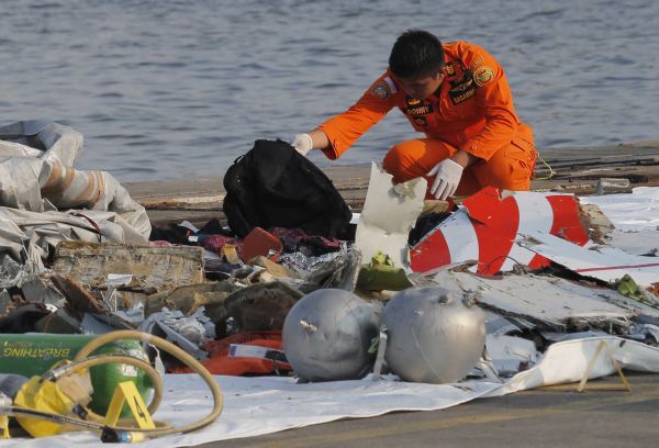 A member of Indonesian Search and Rescue Agency (Basarnas) inspects debris believed to be from the Lion Air passenger jet. (Photo by Tatan Syuflana/AP Photo)
