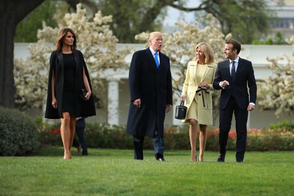 US first lady Melania Trump, US President Donald Trump, Brigitte Macron and French President Emmanuel Macron walk across the South Lawn before participating in a tree-planting ceremony at the White House April 23, 2018 in Washington, DC.