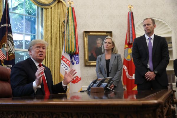 President Donald Trump (L) discusses the potential impact of Hurricane Michael with Homeland Security Secretary Kirstjen Nielsen (C) and FEMA Administrator Brock Long (R) in the Oval Office of the White House on Oct. 10, 2018 in Washington, DC.