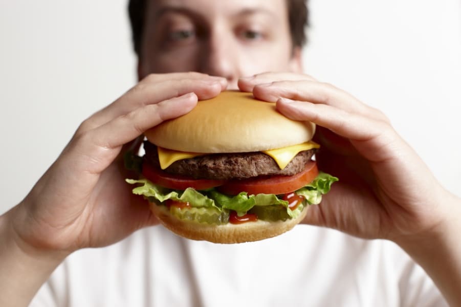 Man eating hamburger close-up