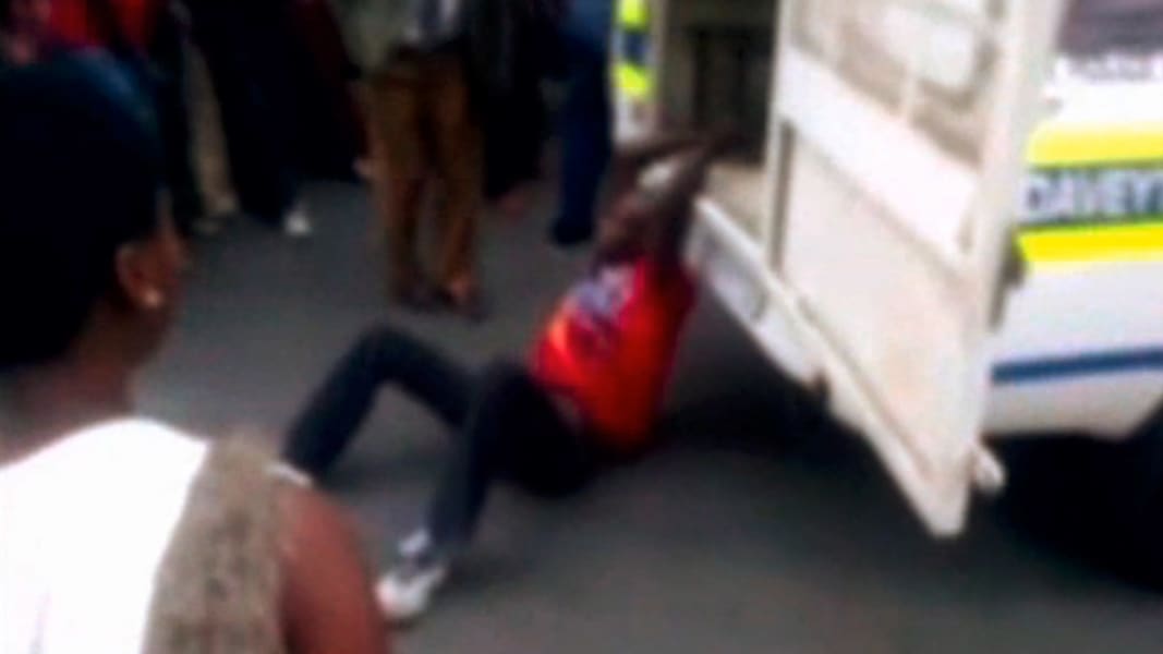 safrica police man drag man
