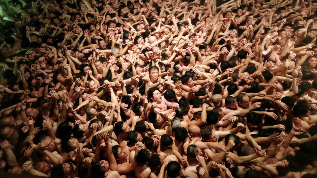 Approximately 10,000 men in loincloths try to snatch a lucky wooden stick during the 'Eyo' naked festival at Saidaiji Temple on February 15, 2020 in Okayama, Japan. After all the lights were turned off, the chief priest tossed a pair of 20-centimetre-long "shingi" sacred sticks from a window 4 meters above ground into the massive throng. Those who left the temple grounds holding the shingi are considered "lucky men" of this year. The Saidaiji-eyo festival, said to date to the Muromachi Period (1338-1573). (Photo by The Asahi Shimbun via Getty Images )