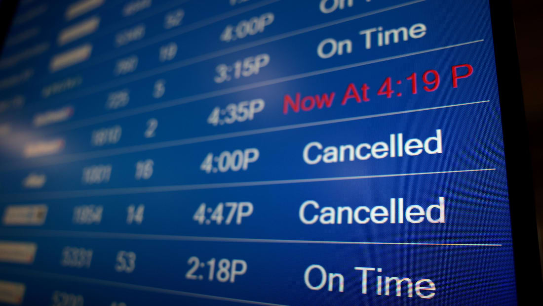 A flight information display system shows departure times at the Ronald Reagan Washington National Airport on December 27, 2021 in Arlington, Virginia. 