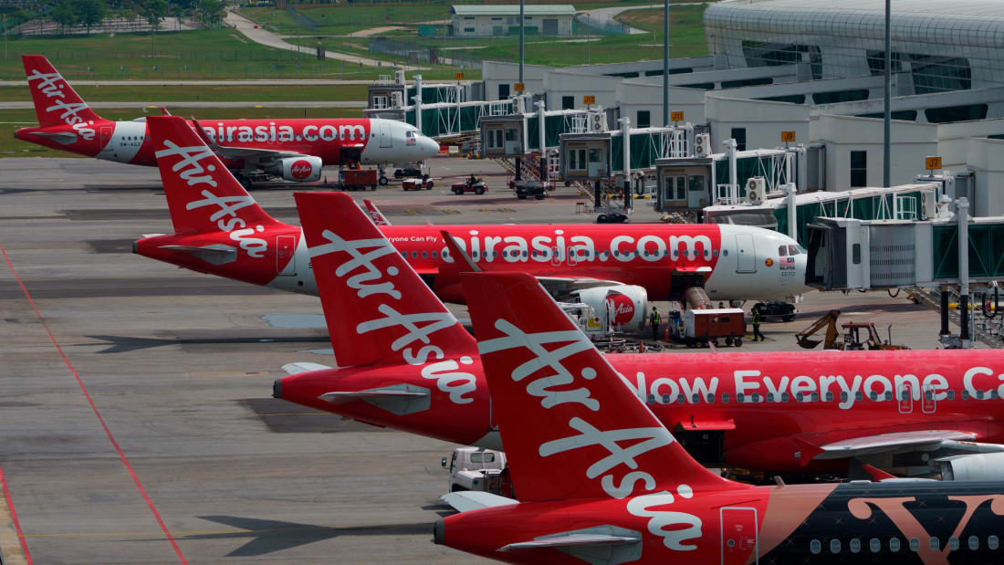 AirAsia Airbus planes sit on the tarmac at a terminal in Sepang, Malaysia, Monday, Nov. 15, 2021.