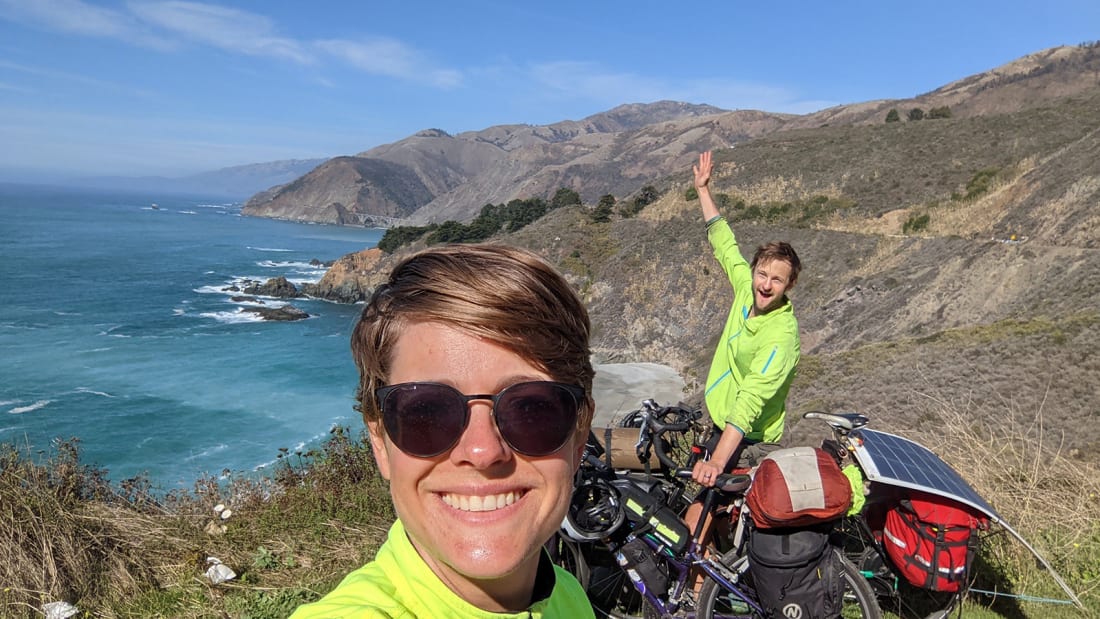 Will and Claire Stedden, posing in Big Sur, with their bikes.