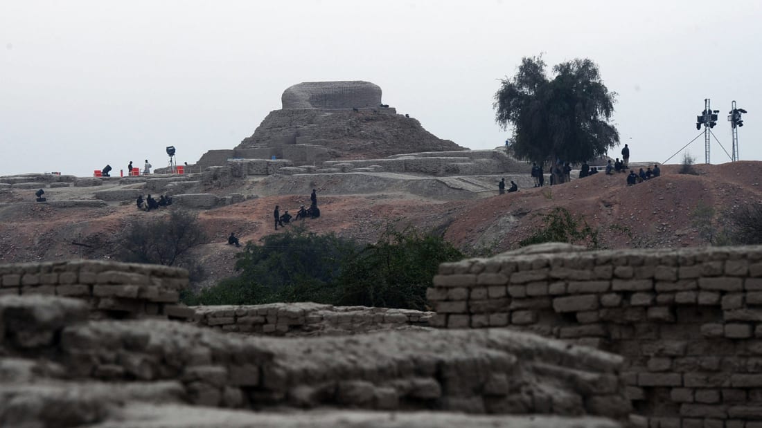 Pakistani policemen sit around the ancient ruins of Moenjodaro, the UNESCO World Heritage site around 425 kilometres north of the port city of Karachi on February 1, 2014.