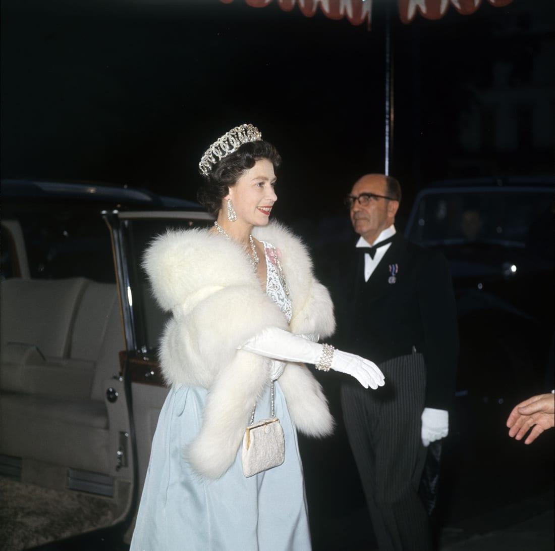 Queen Elizabeth II arriving at the Austrian Embassy in London bedecked in jewels.