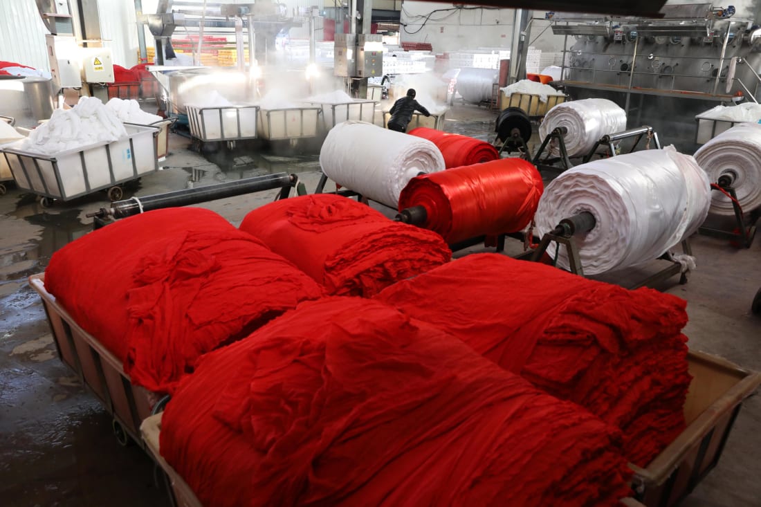 A man works in a fabric dye factory in Hangzhou in east China's Zhejiang province in January 2020.
