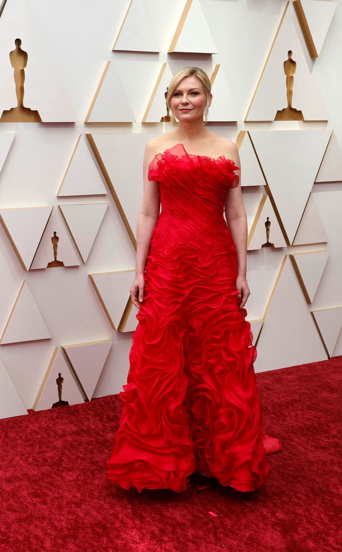 Best Supporting Actress nominee for "The Power of the Dog" Kirsten Dunst in a red Chanel gown with ruffles.