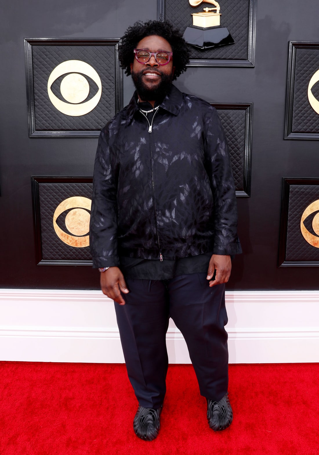 Questlove kept things casual in a dark patterned jacket and a pair of Crocs. 