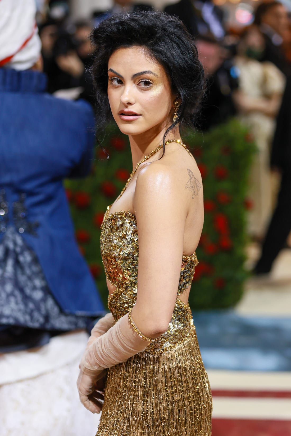 Camila Mendes opted for a fringed gold dress with sequined top and cut-out.