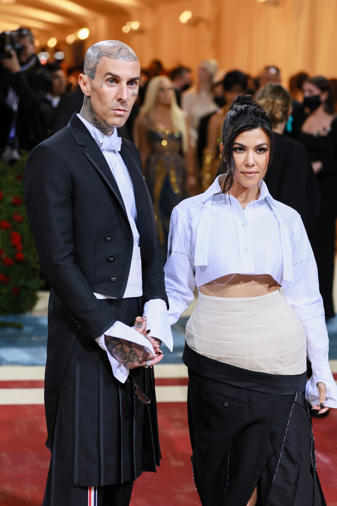 Travis Barker and Kourtney Kardashian wore complementary Thom Browne looks to the Met Gala, with the designer explaining Kardashian's look was a "deconstructed interpretation" of Barker's tailcoat, kilt and cumberbund.