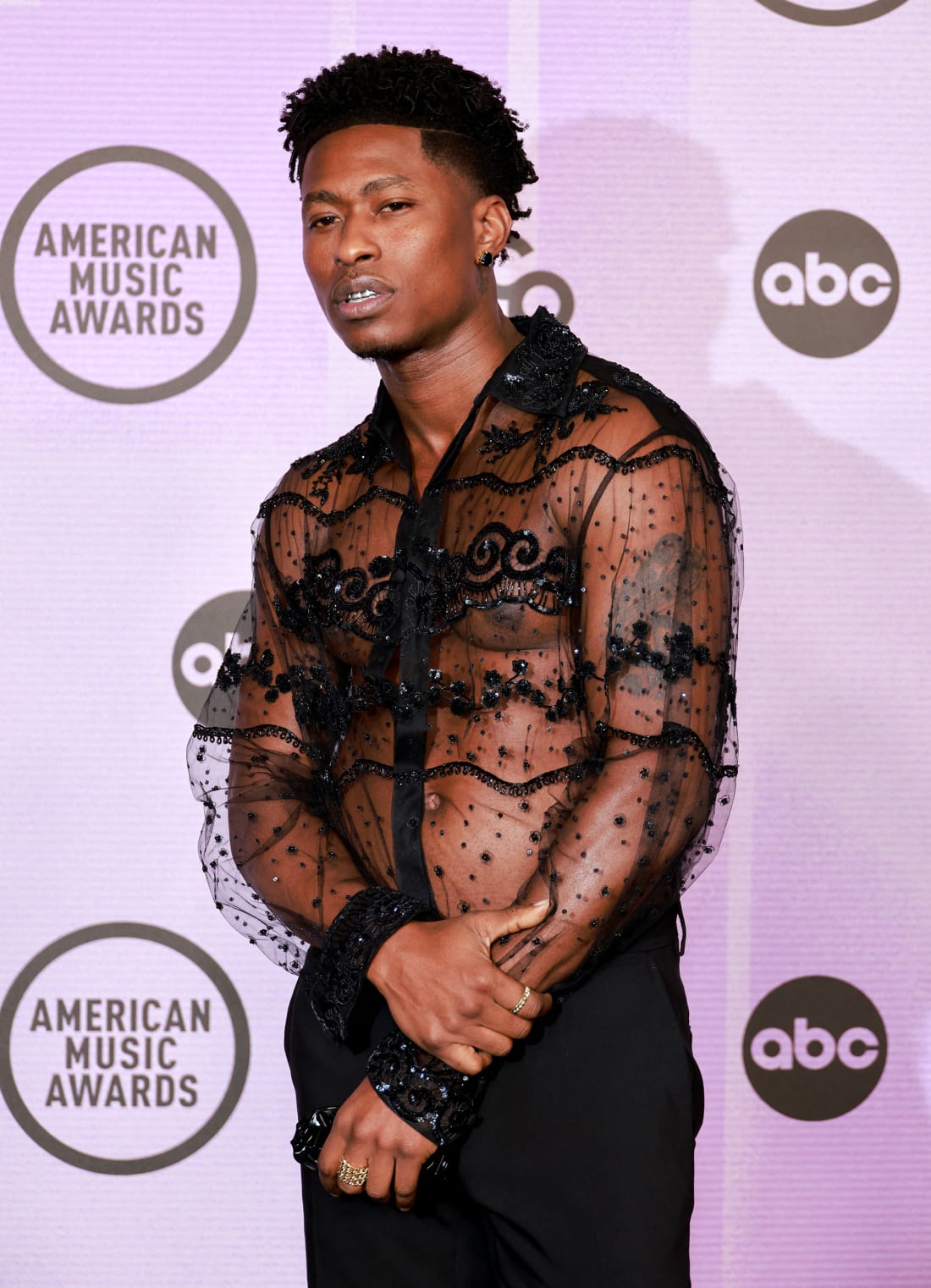 Lucky Daye wore an embroidered sheer shirt by Valentino. 
