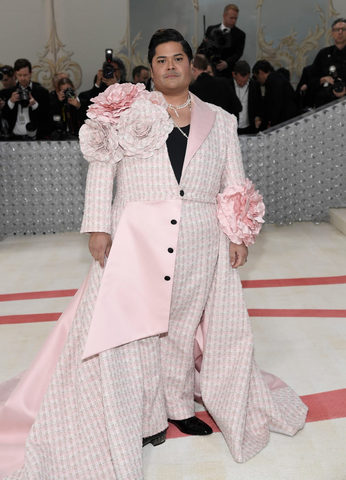 Actor Harvey Guillen set the tone early in a pink bustled jacket by Christian Siriano with oversized floral embellishments.
