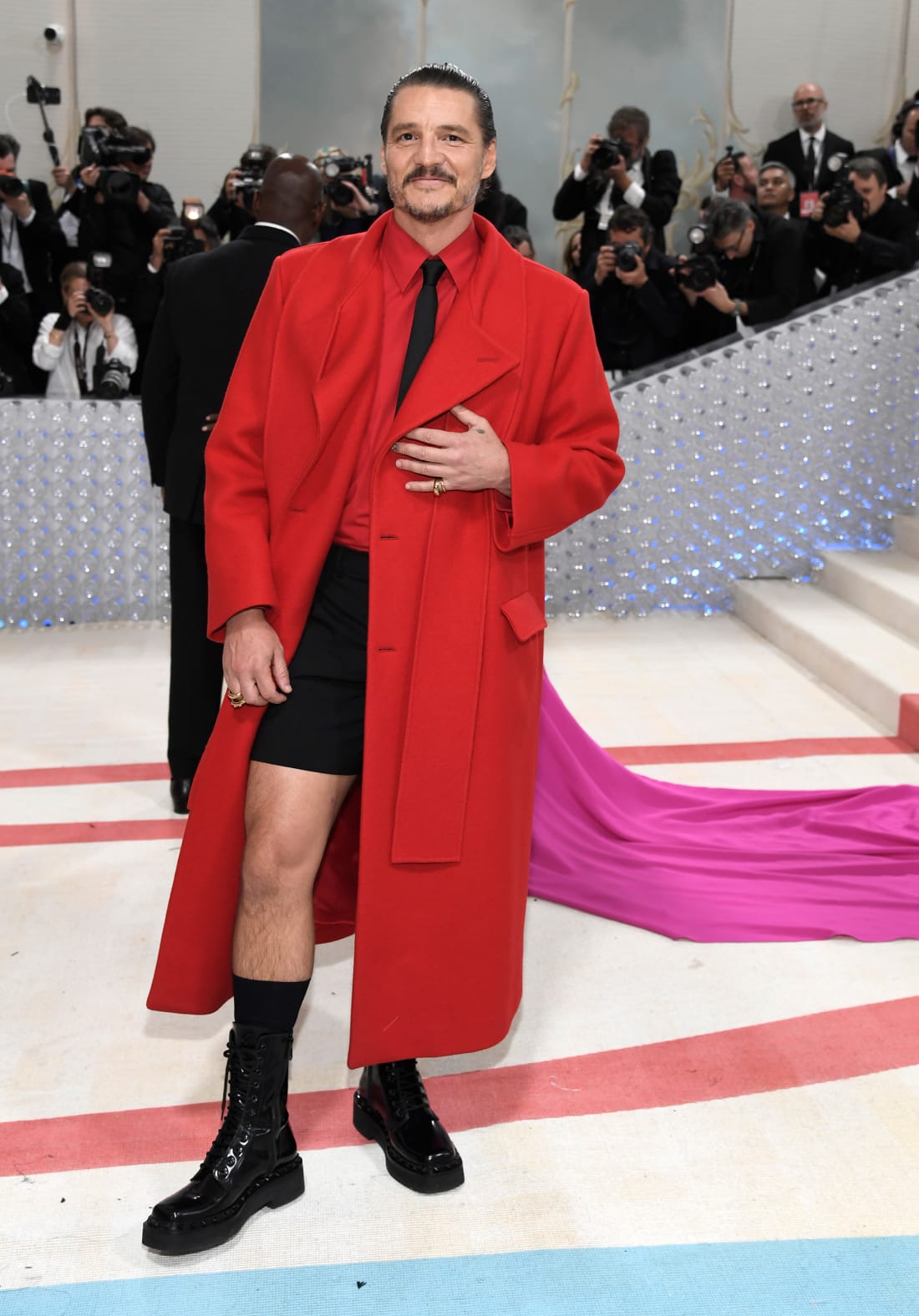 Pedro Pascal — the internet's "daddy" — wore Valentino, pairing black shorts with a long red coat.