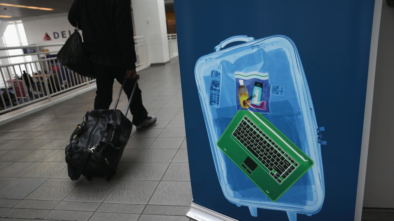  A traveler walks past a newly-opened TSA Pre-check application center at Terminal C of the LaGuardia Airport on January 27, 2014 in New York City.