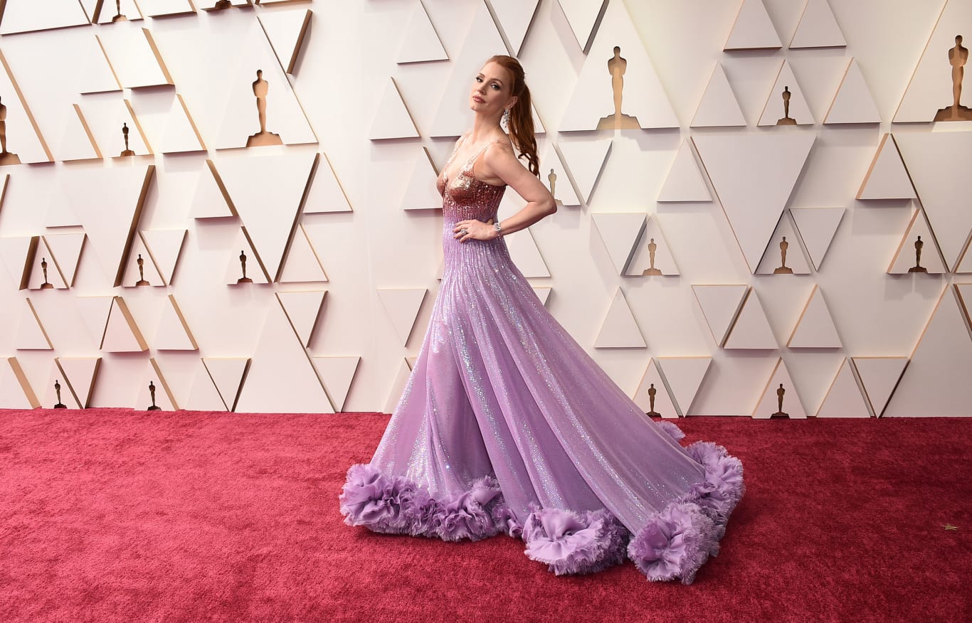 Jessica Chastain, best actress nominee for "The Eyes of Tammy Faye," dressed in Prada for the ceremony, sporting a bronze-to-lavender color with a flowing train. 